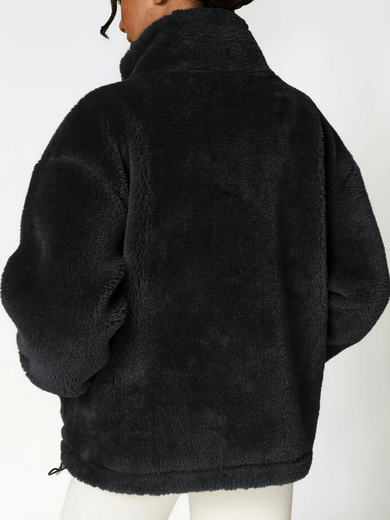 Back view of long sleeved outdoor loose fitting lamb fleece jacket in black, perfect for yoga and outdoor exercises. Made of 100% polyester.