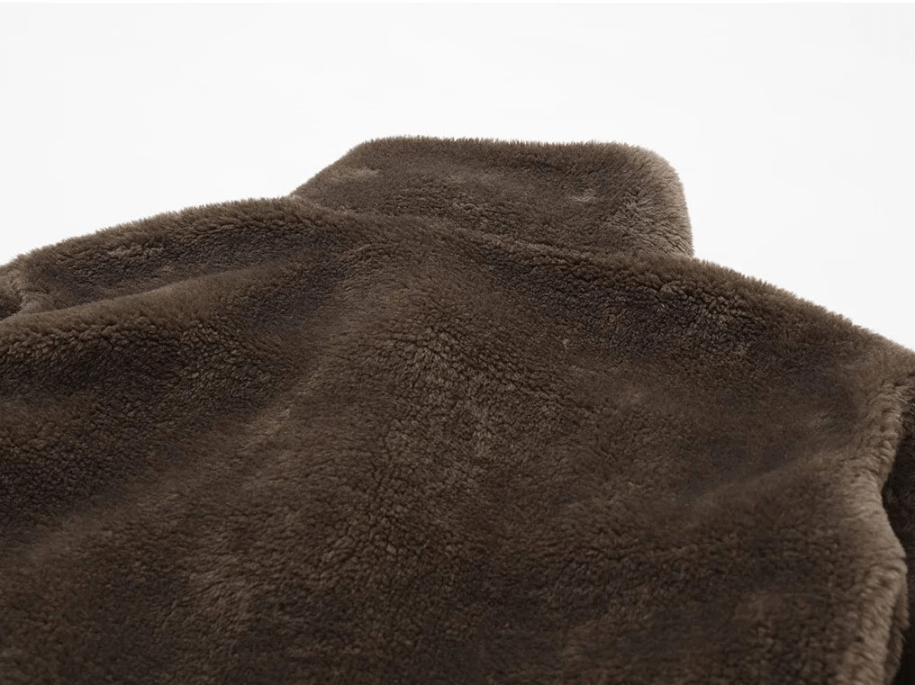 Close-up of brown lamb fleece texture on outdoor jacket SF1837, showcasing its plush and cozy finish for active lifestyles.