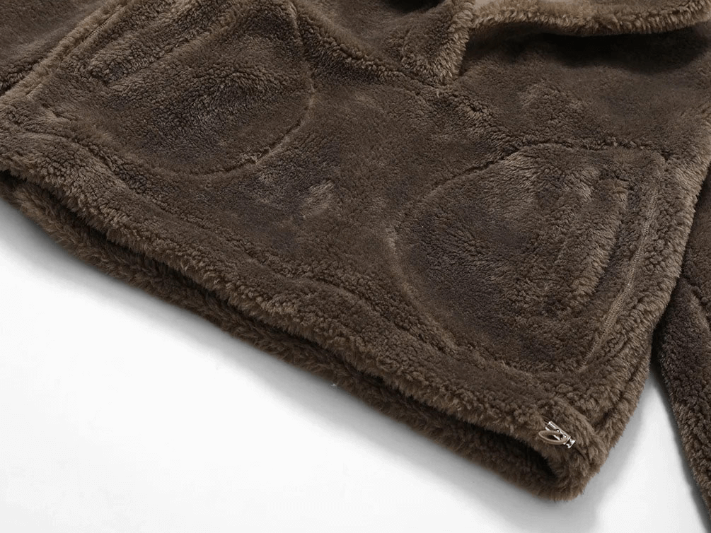 Close-up of brown lamb fleece jacket, showcasing plush texture and pockets. Perfect for outdoor activities and yoga.