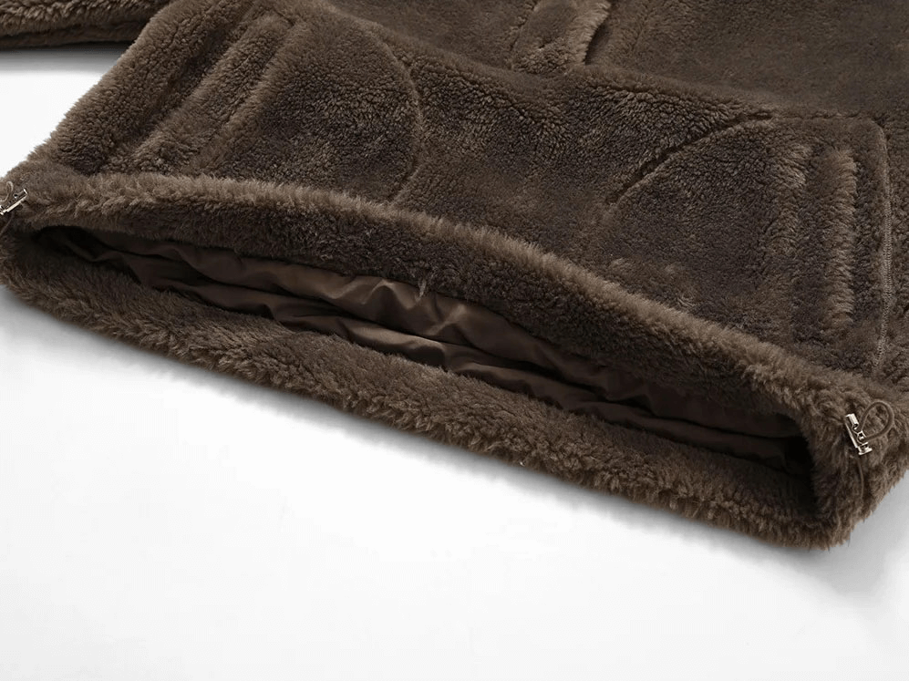 Close-up of Long Sleeved Outdoor Loose Fitting Lamb Fleece Jacket hem showing plush texture and drawstring detail.
