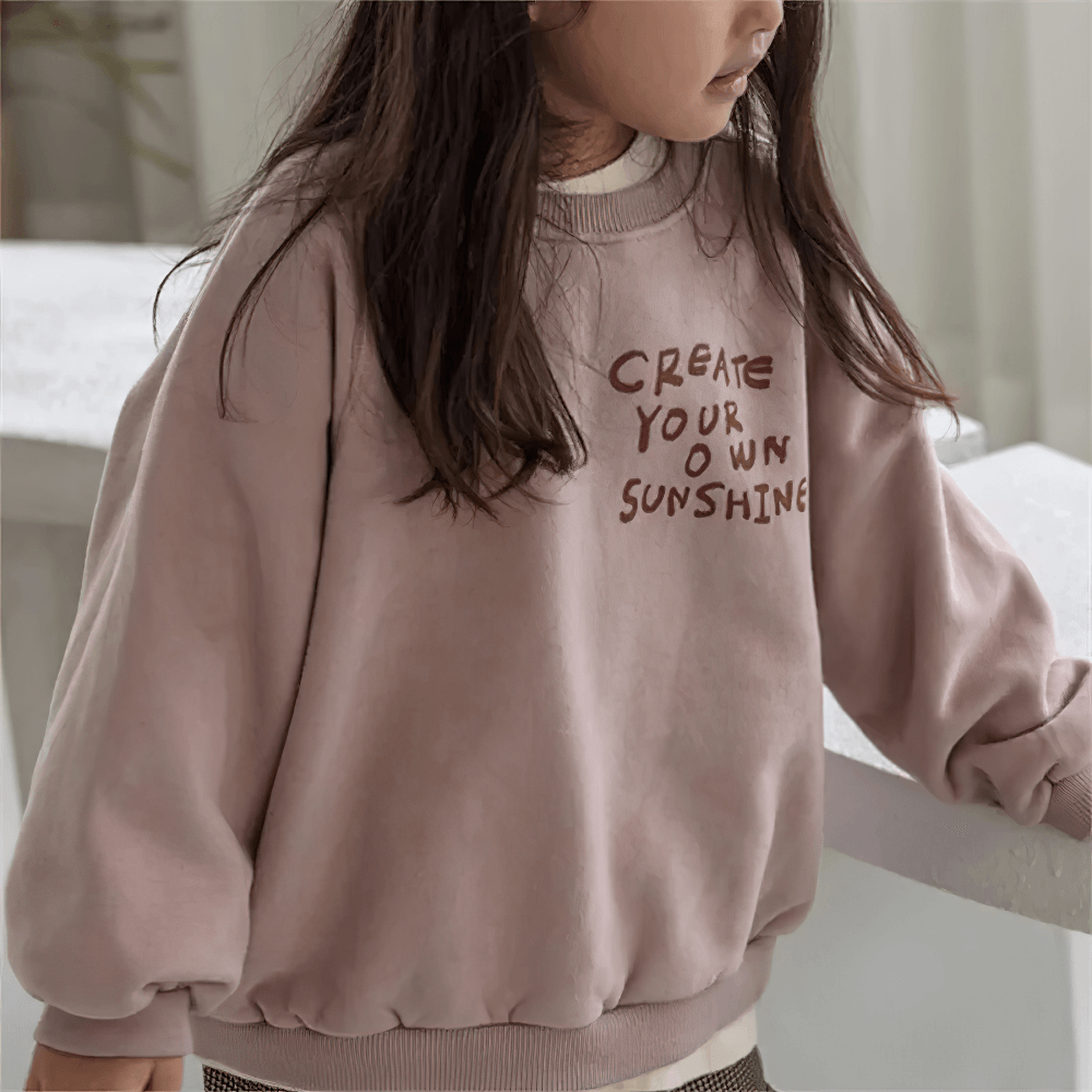 Girl wearing Long-Sleeved Sweatshirt With Letter Print - SF3555, showcasing 'Create Your Own Sunshine' design in a cozy setting.