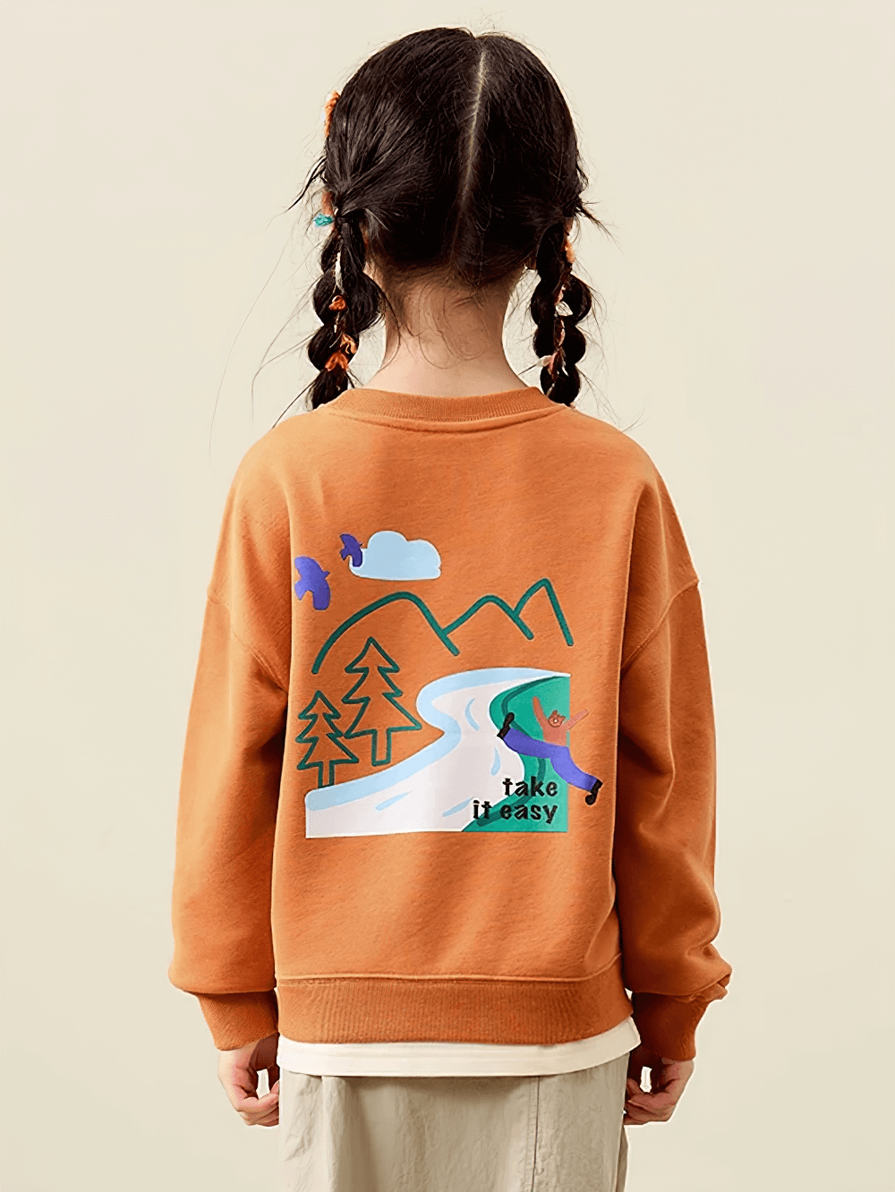 Kid wearing a long-sleeved sweatshirt with mountain and nature design, featuring 'Take it Easy' message in vibrant colors. Product code SF3095.