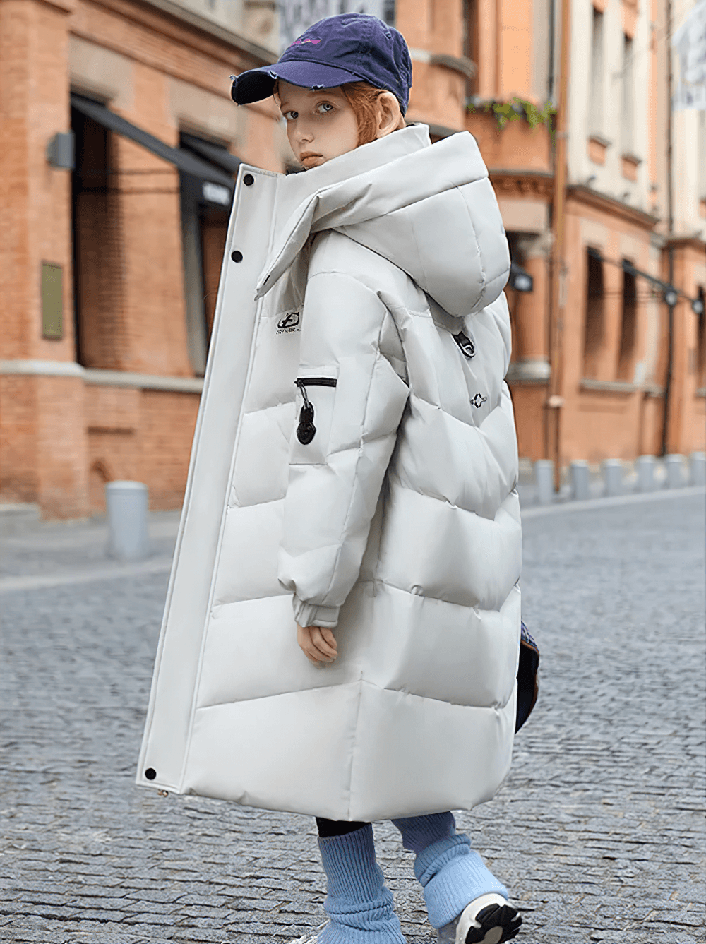 Child wearing Long White Duck Down Jacket with Hood and Zipper - SF3631, stylish winter coat ideal for cold weather and travel, street scene.