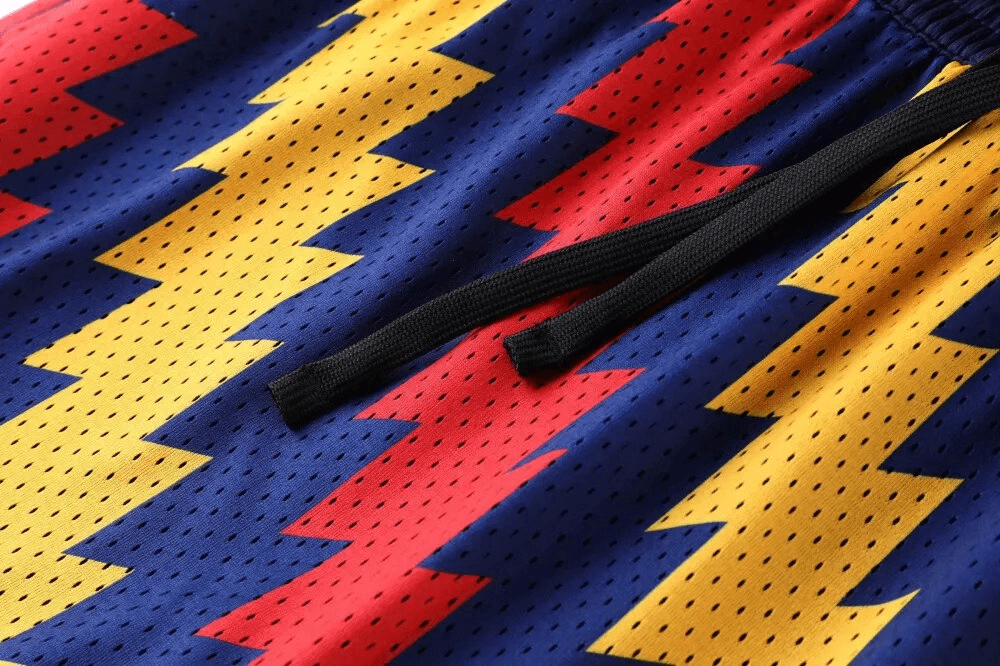 Colorful zigzag-patterned breathable basketball shorts with drawstring, featuring quick dry polyester fabric. Perfect for active sports.