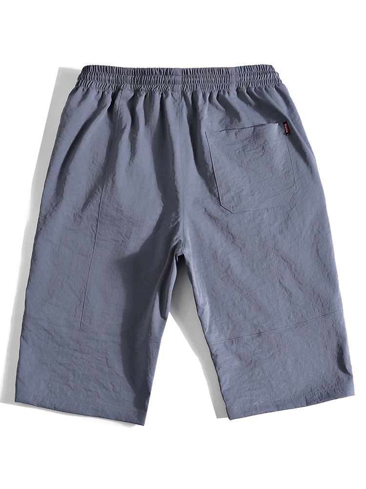 Back view of blue loose breathable drawstring calf-length shorts for men with pockets, SF1351 style.