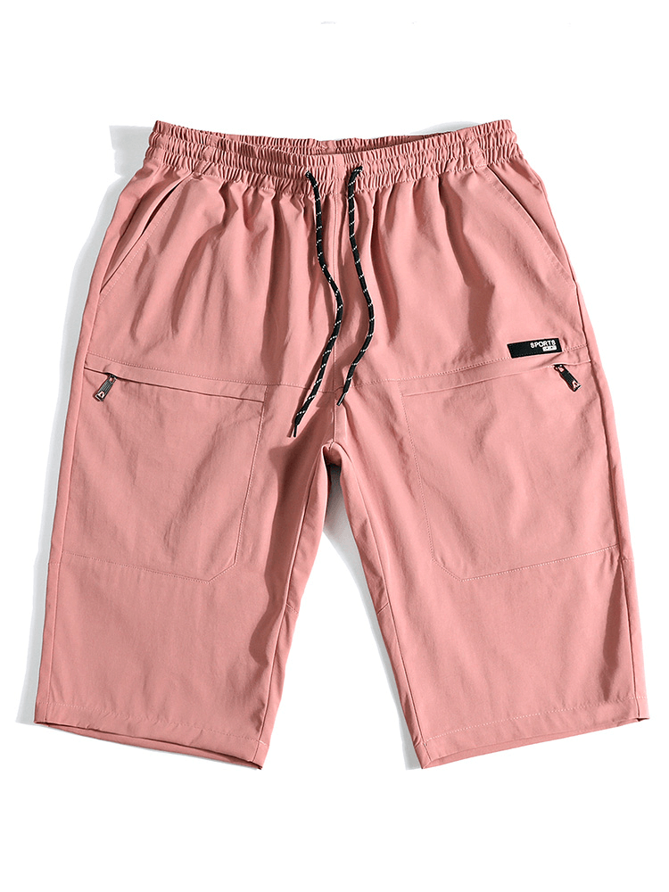 Pink loose breathable drawstring calf-length shorts for men with pockets, made from spandex and polyester for comfort and style.