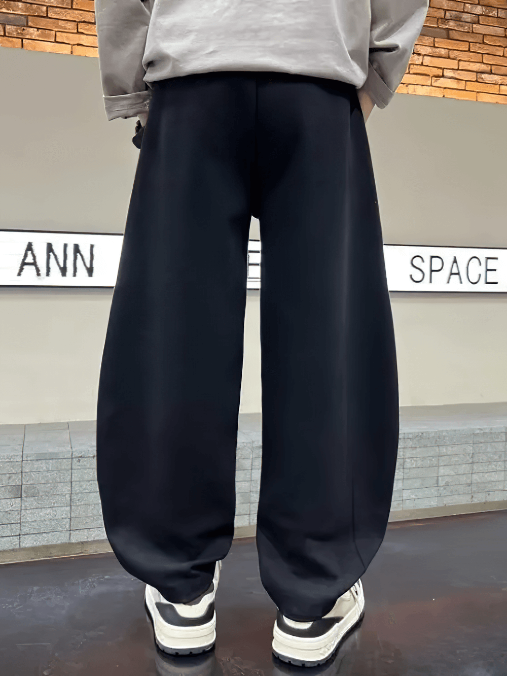 Back view of Loose Fit Sporty Cargo Pants with Elastic Waist - SF3710 in black, worn by a model, showing casual and comfortable design.