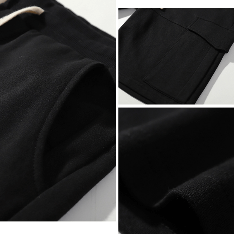 Close-up of black loose multi-pocket breathable sports shorts with drawstring, ideal for gym and sports. Made from cotton.