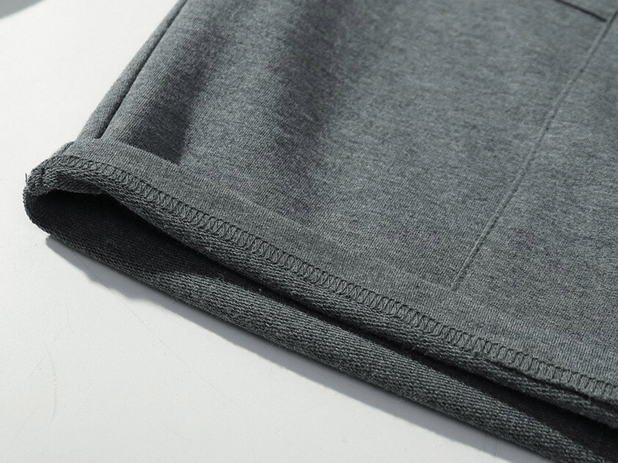 Close-up of gray breathable sports shorts for men, showcasing multi-pocket and cotton fabric details.