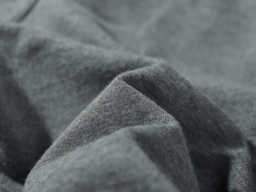 Close-up of soft gray cotton fabric used in breathable men's sports shorts.