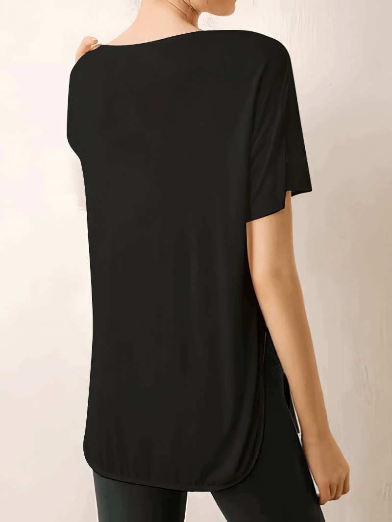 Woman wearing a loose black round neck t-shirt for yoga, made of breathable Spandex fabric, ideal workout clothes for women.