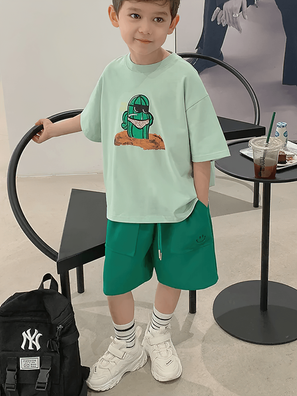 Child wearing Loose Shorts with Front Pockets and Fun Design - SF3772, featuring smiley face detail and sporty fit in a casual setting.