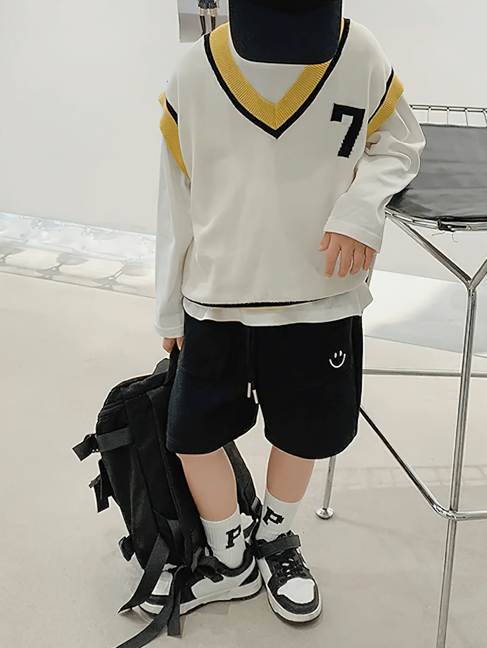 Child's outfit featuring Loose Shorts with Front Pockets and Fun Design - SF3772, black sneakers, and a sporty top.