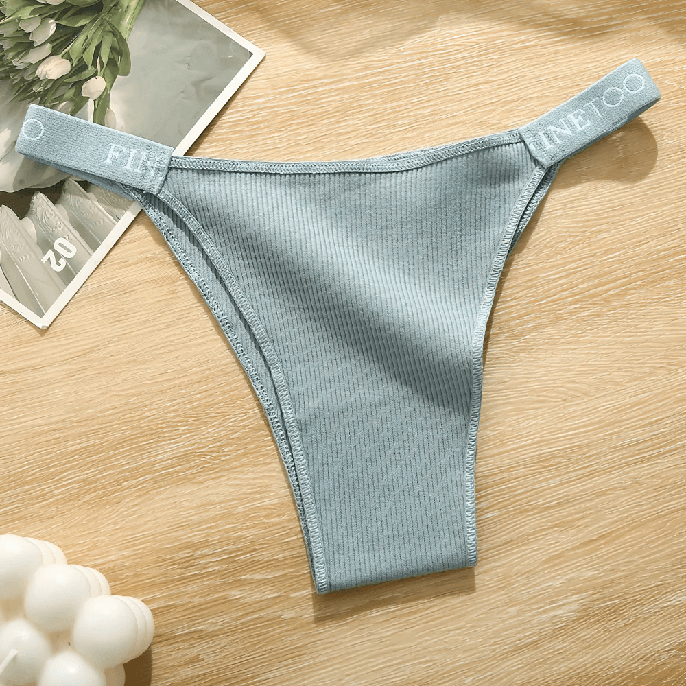 Low Waist Ribbed Cotton Thong Panties for Women - SF4631 in soft blue color with logo waistband on wooden surface.