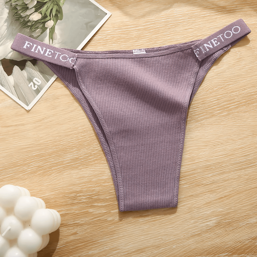 Low Waist Ribbed Cotton Thong Panties for Women - SF4631 in stylish purple color on a wooden surface.