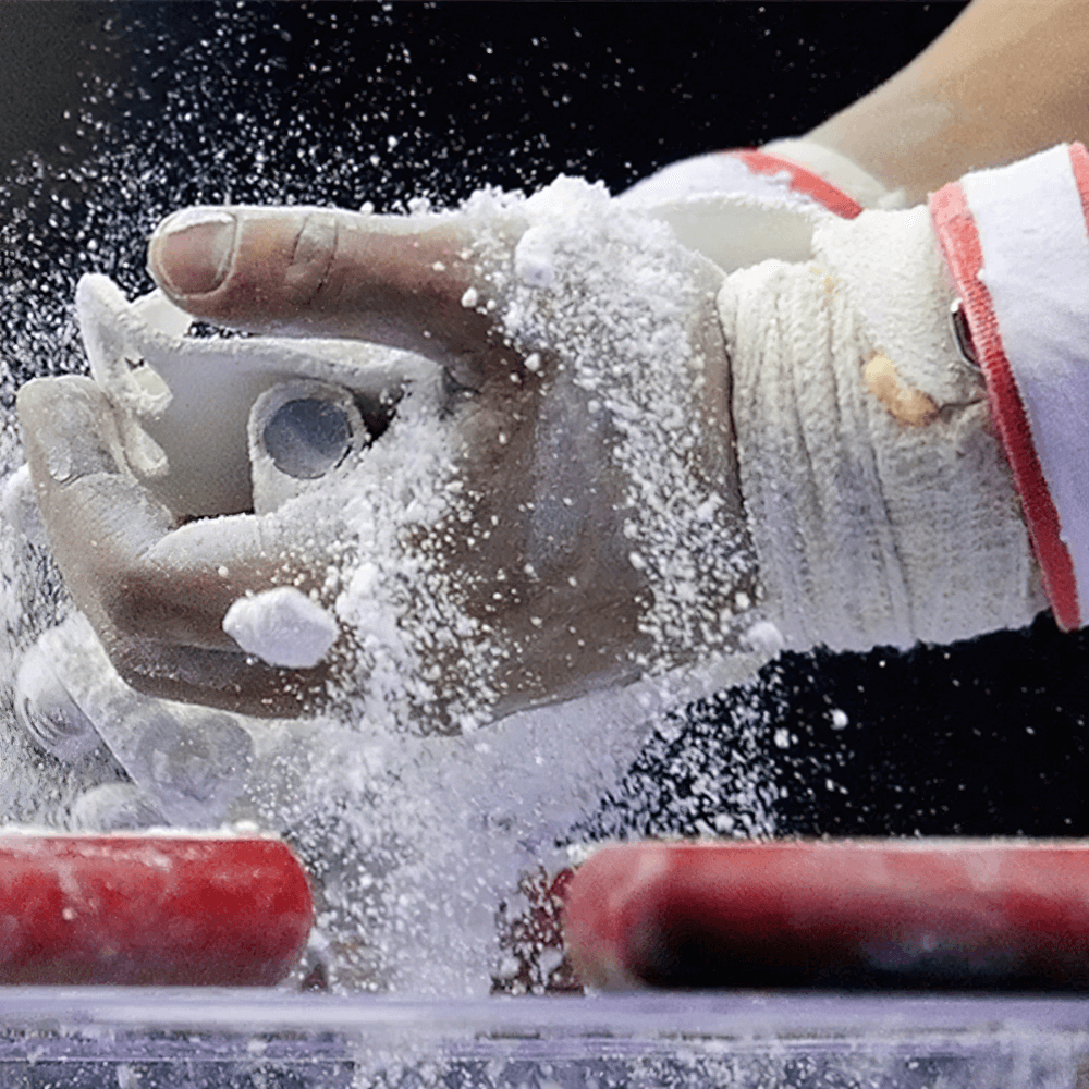 Athlete applying Magnesium Carbonate Gym Chalk Blocks for Training - SF3456 during a weightlifting session for better grip.