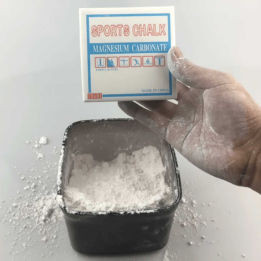 Hand holding Magnesium Carbonate Gym Chalk Blocks for Training - SF3456 over a container of chalk powder, enhancing grip for athletes.