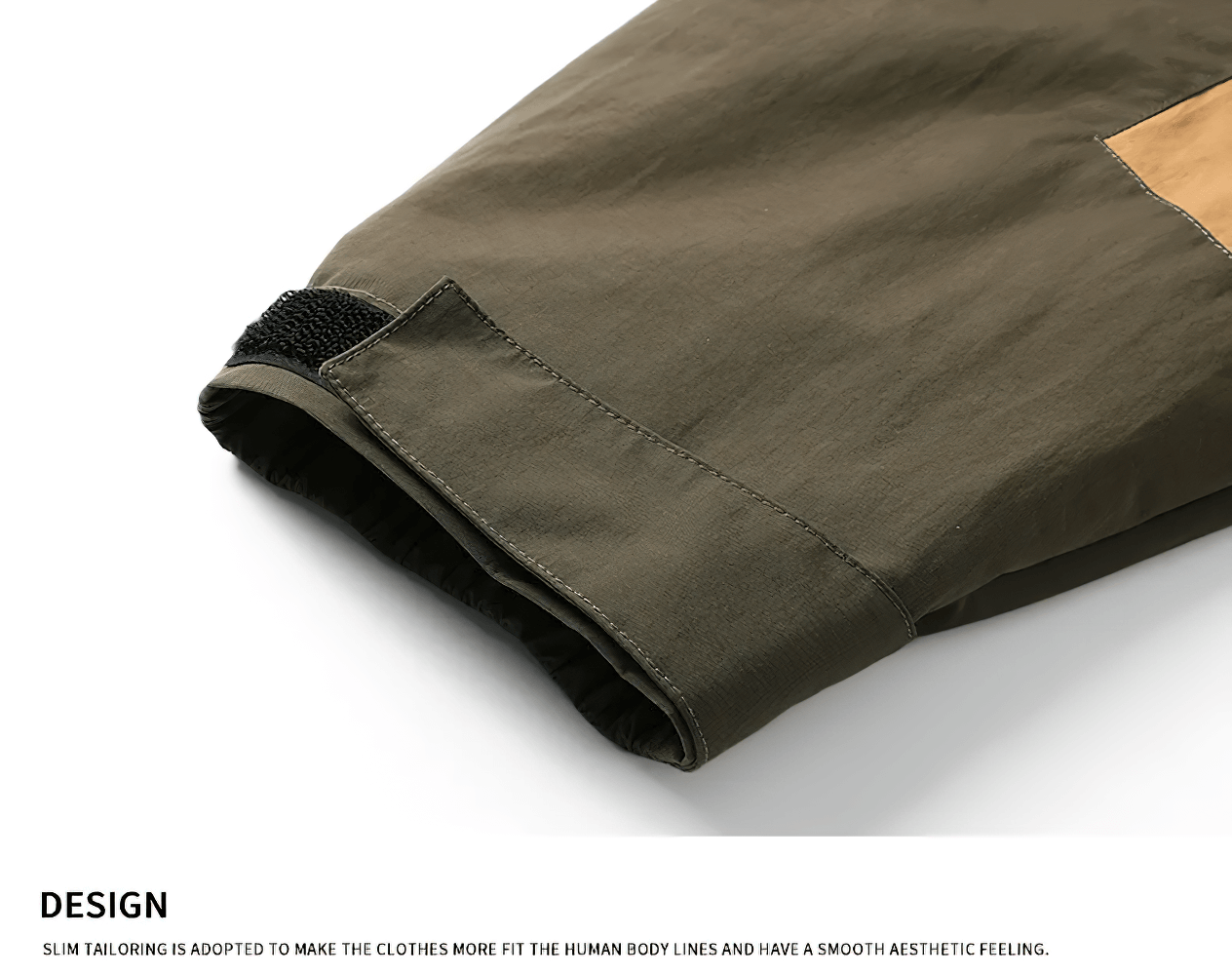 Close-up of cuff on green and brown windproof outdoor jacket, showcasing slim tailoring and design details.