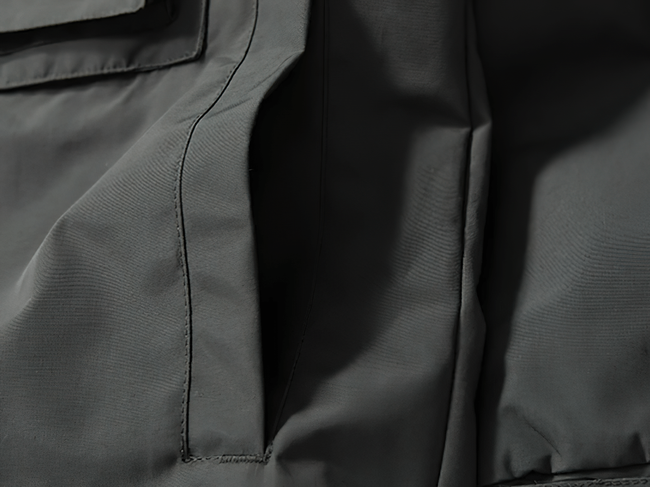 Close-up of the multi-pocket design on the male outdoor windproof jacket SF2268, showing durable fabric and sleek stitching.