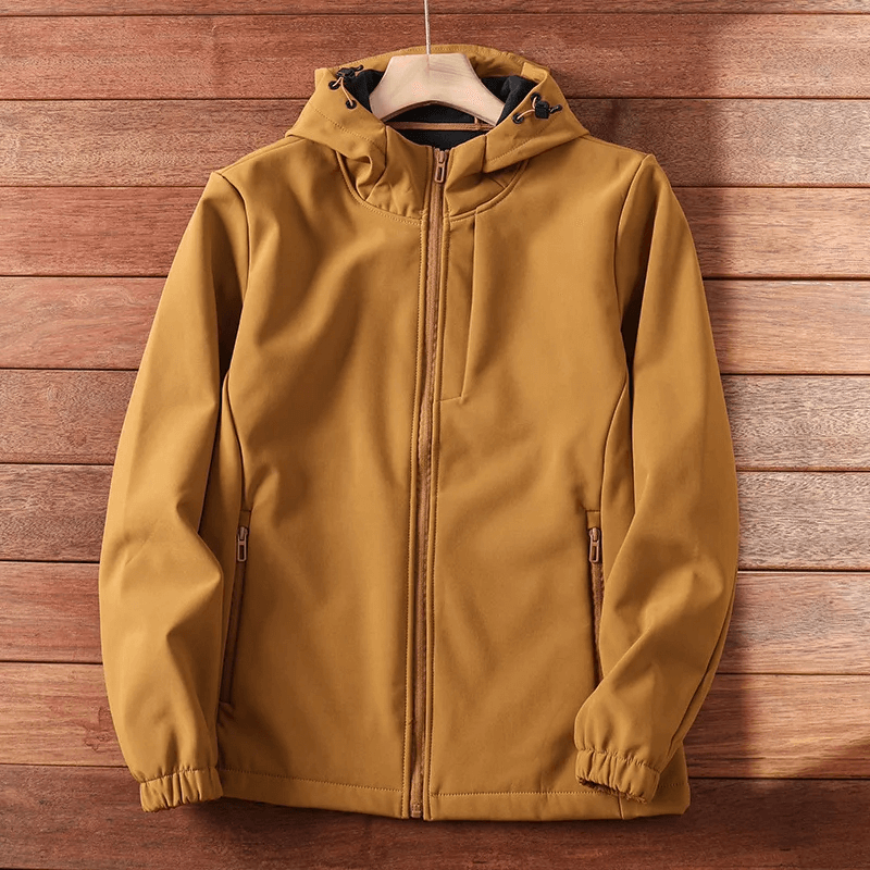 Durable waterproof brown hiking and camping jacket on wooden background, perfect for outdoor adventures.