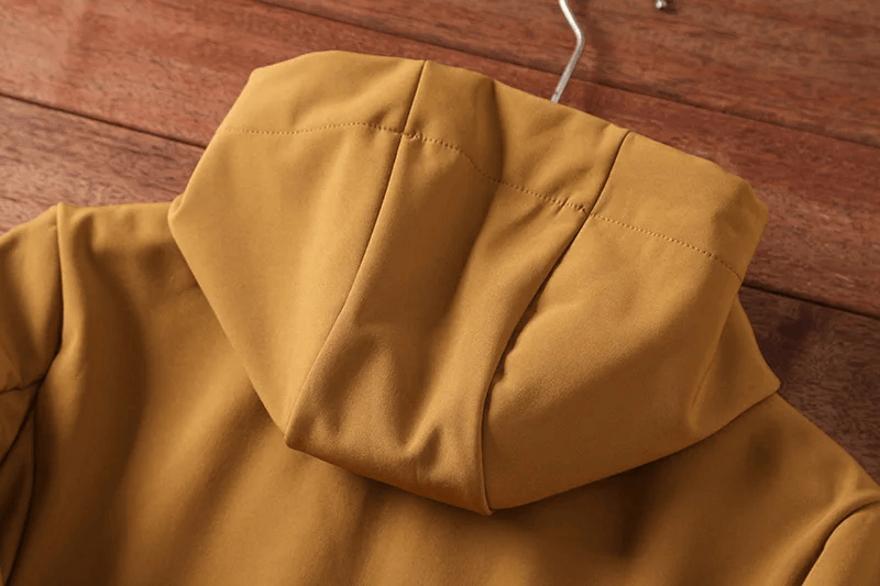 Back view of a durable waterproof hiking jacket with hood, perfect for outdoor adventures in varied weather conditions.