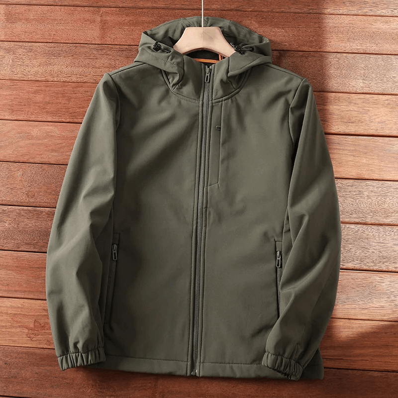 Durable waterproof outdoor hiking and camping jacket, SF2207, with windproof and thermal features, in olive green, hanging on wooden wall.