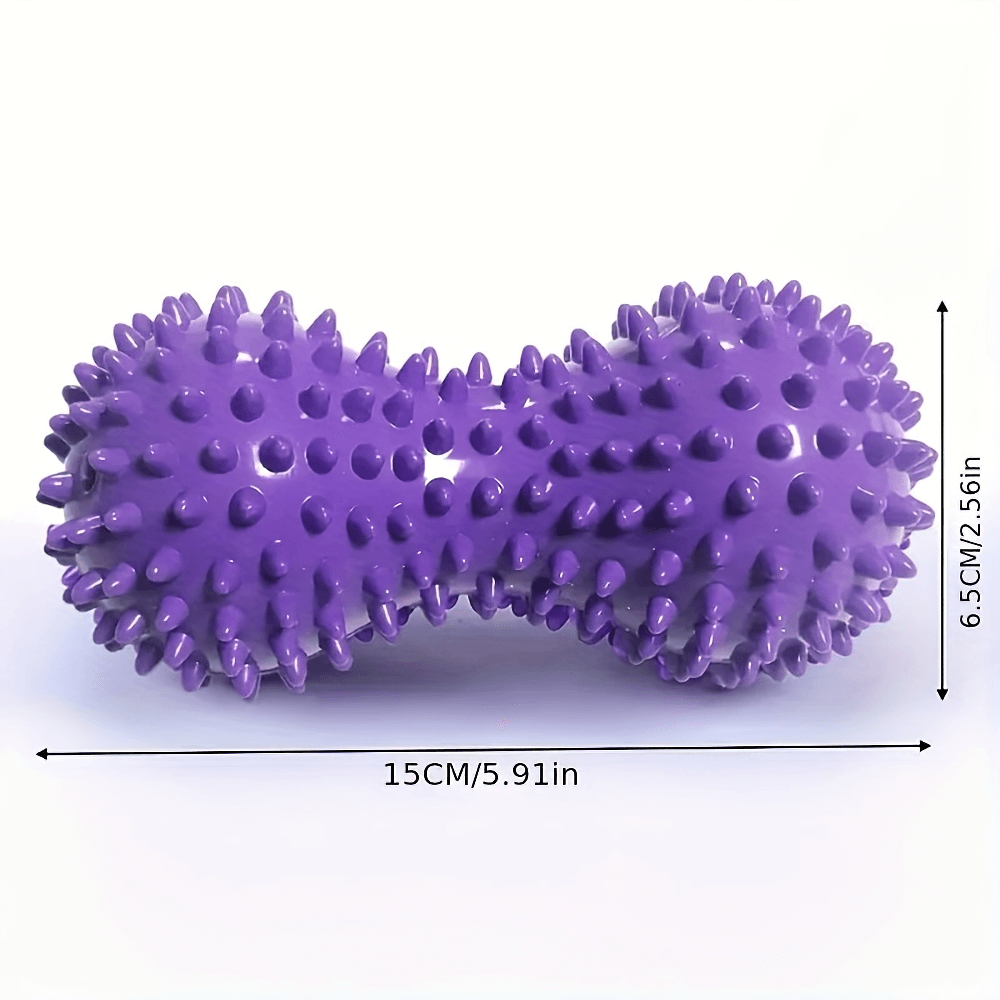 Purple spiky peanut-shaped massage ball for deep tissue relief, ideal for feet, back, and body. Dimensions: 15cm x 6.5cm.