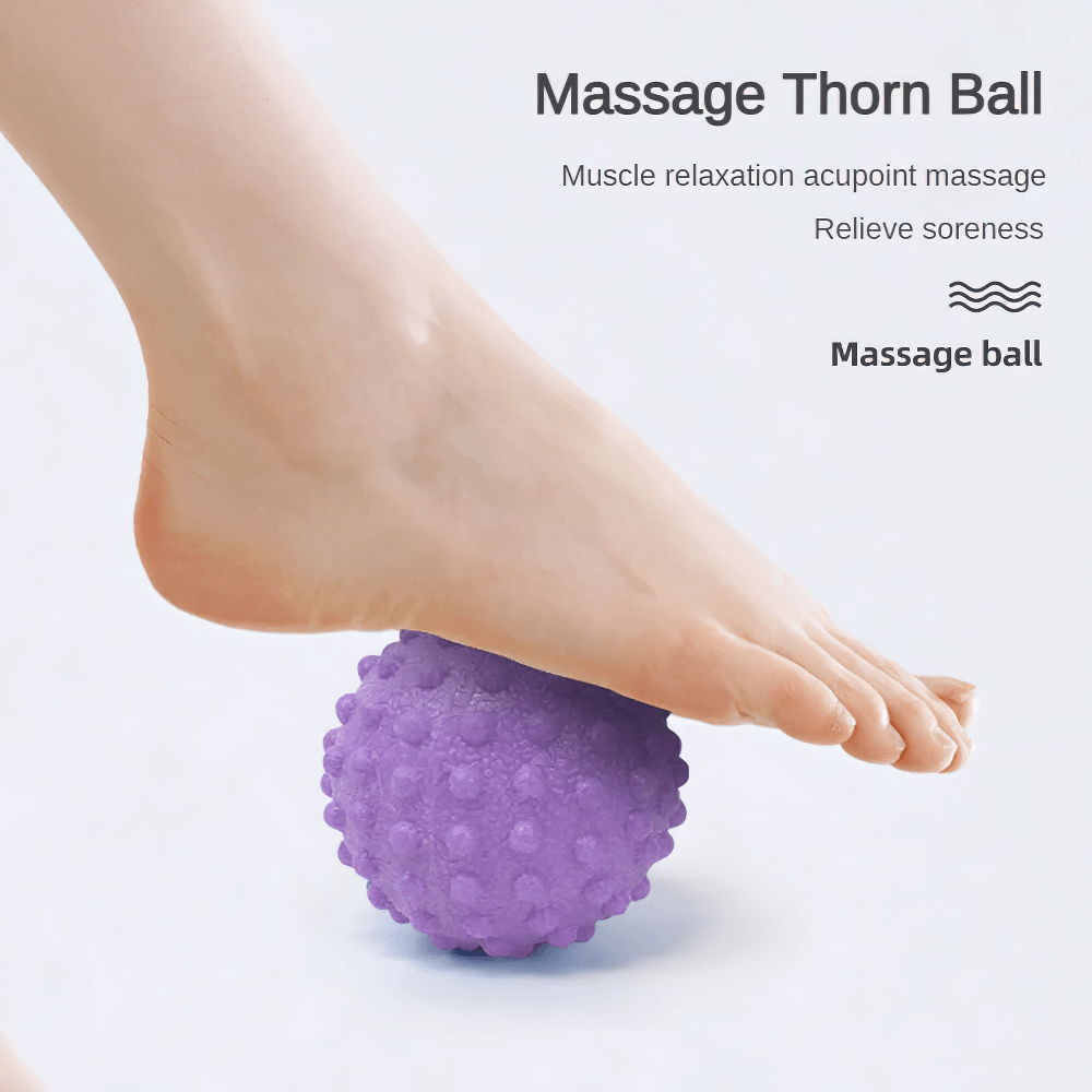 Foot using purple spiky massage ball for deep muscle relaxation and pain relief.