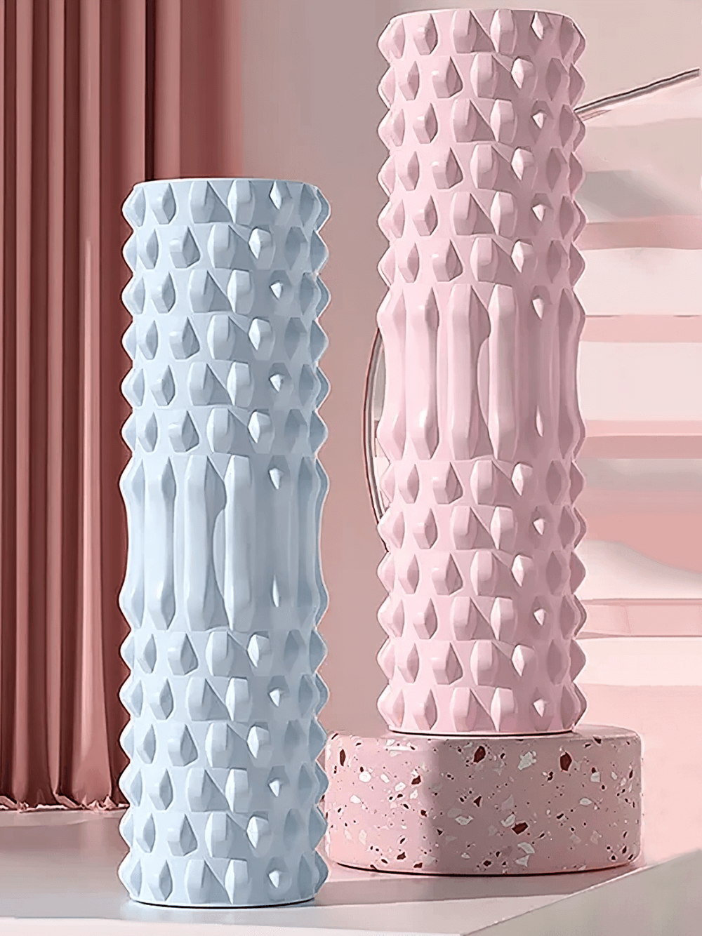 Blue and pink Eva foam massage rollers for deep tissue muscle relief and flexibility.