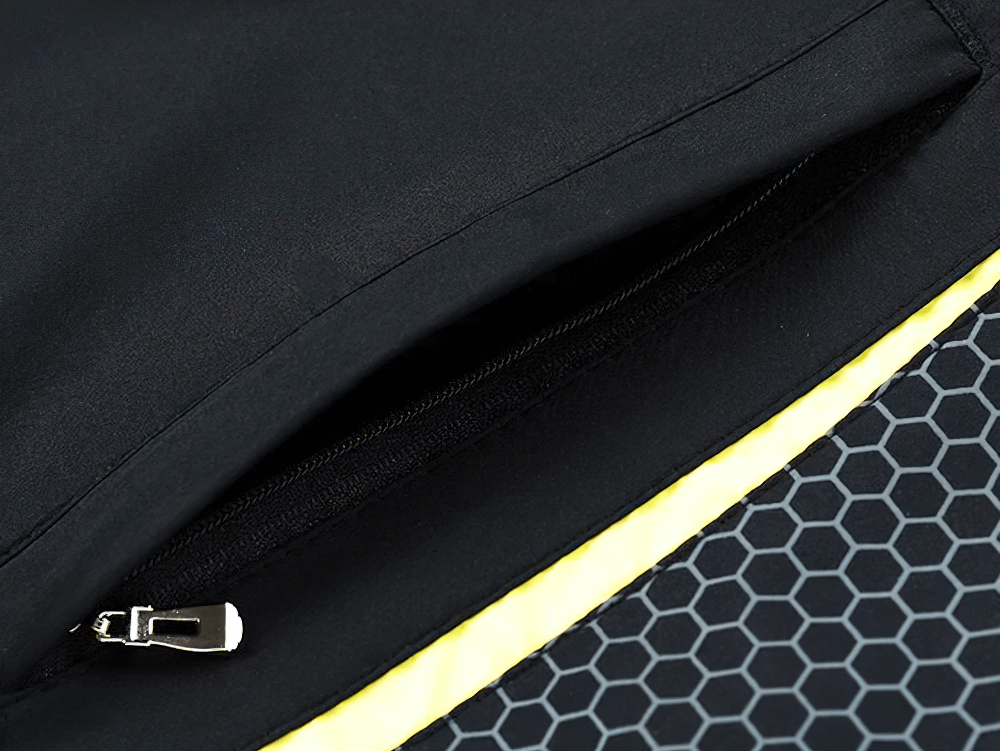 Close-up of a zip pocket on a black sports tracksuit with hexagon pattern detail, featuring stylish and practical design elements.