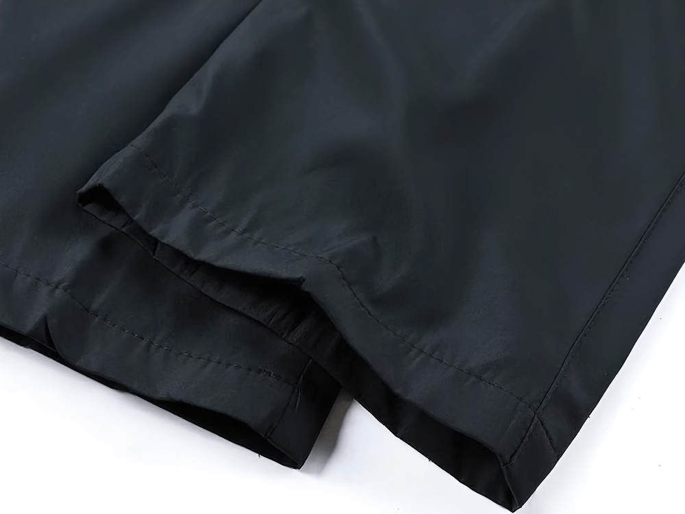 Close-up of a T90 men's active sports tracksuit black pants showing durable polyester and precise stitching.