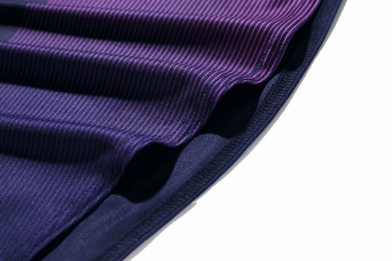 Close-up of purple striped fabric from men's athletic tank top, highlighting breathable, moisture-wicking material.