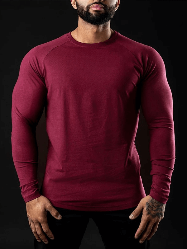 Men's solid color long sleeve workout top in red, showcasing fitness-ready style and breathable cotton design for gym enthusiasts.