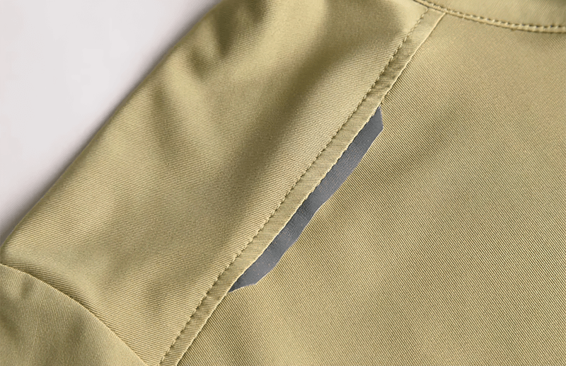 Close-up of breathable green running t-shirt with zipper fit, highlighting the seam and material for optimal performance and comfort.