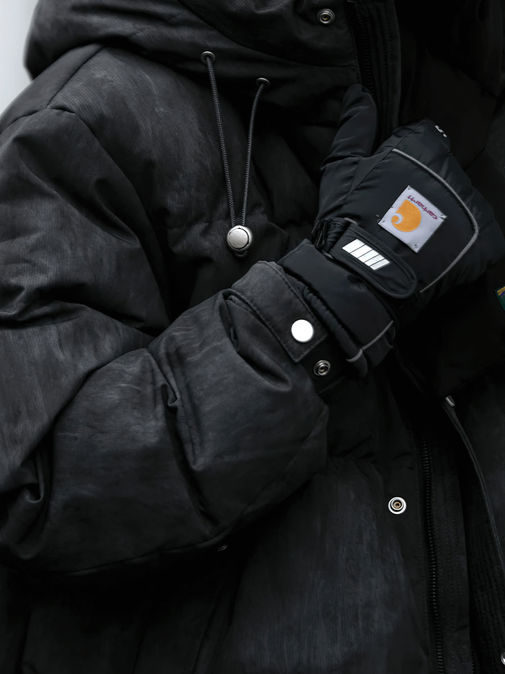 Men's lightweight duck down puffer jacket with hood in black. Thick winter streetwear style, perfect for warmth and fashion.