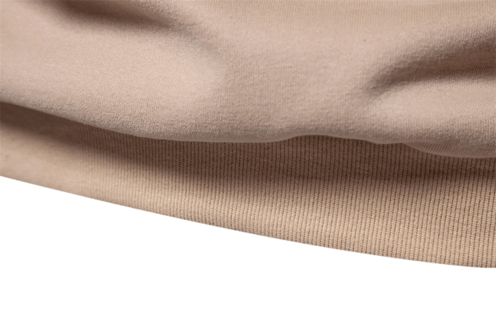 Close-up of the beige fabric texture on the Men's Patchwork Adventure Print Crewneck Sweatshirt, showcasing its soft and breathable material.