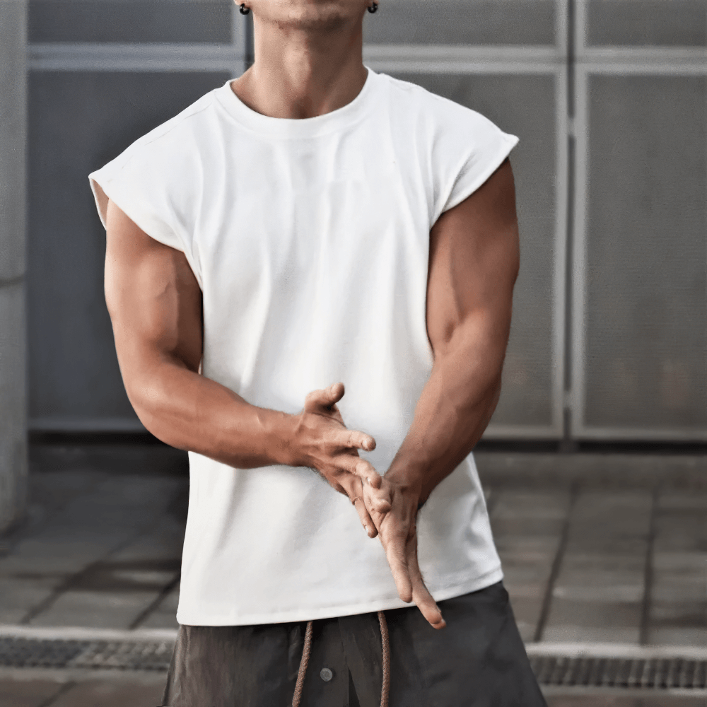 Man wearing a white sleeveless sport t-shirt with an O-neck and slim fit, perfect for gym workouts and bodybuilding sessions.