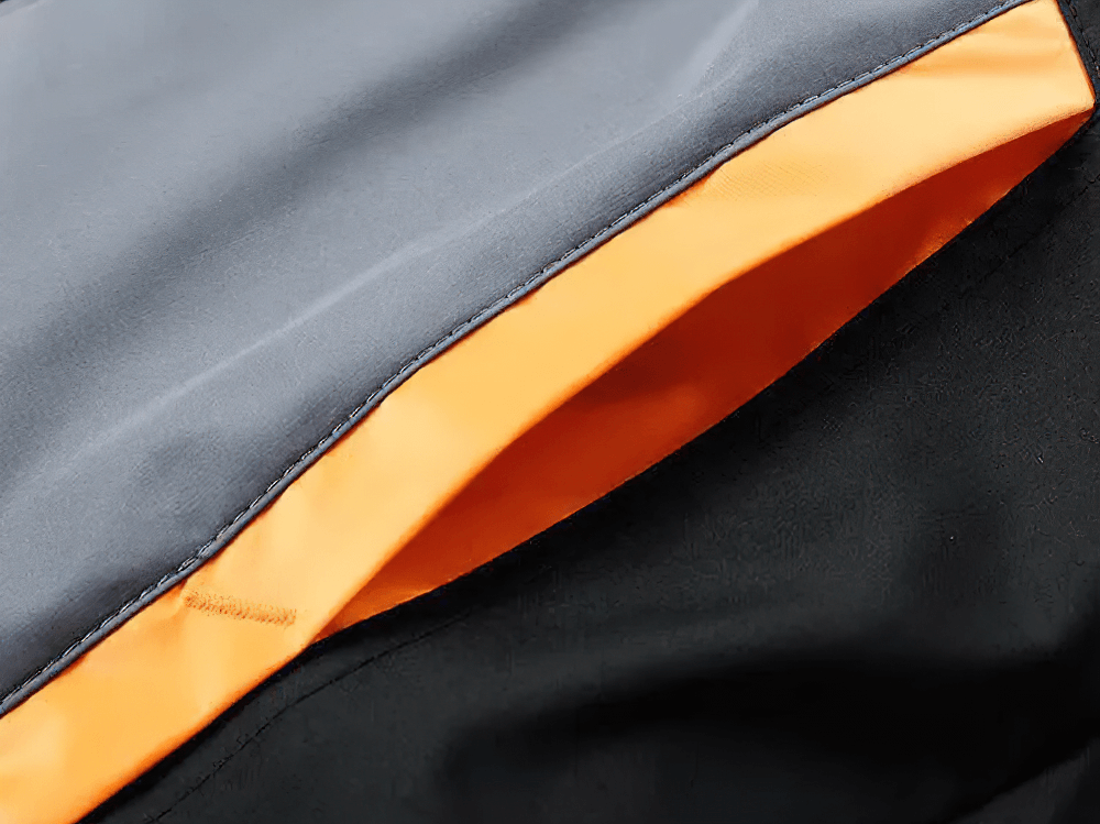 Close-up of the T90 Men's Sports Tracksuit featuring bold orange accents, showcasing breathable and durable fabric ideal for outdoor training.