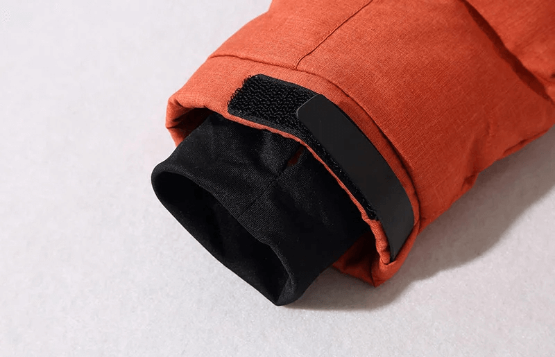 Close-up of cuff detail on men's windproof ski jacket from breathable ski suit, showing durable material and secure velcro fastening.