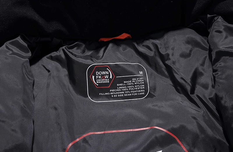Black windproof ski jacket highlighting the inner label of materials and size.