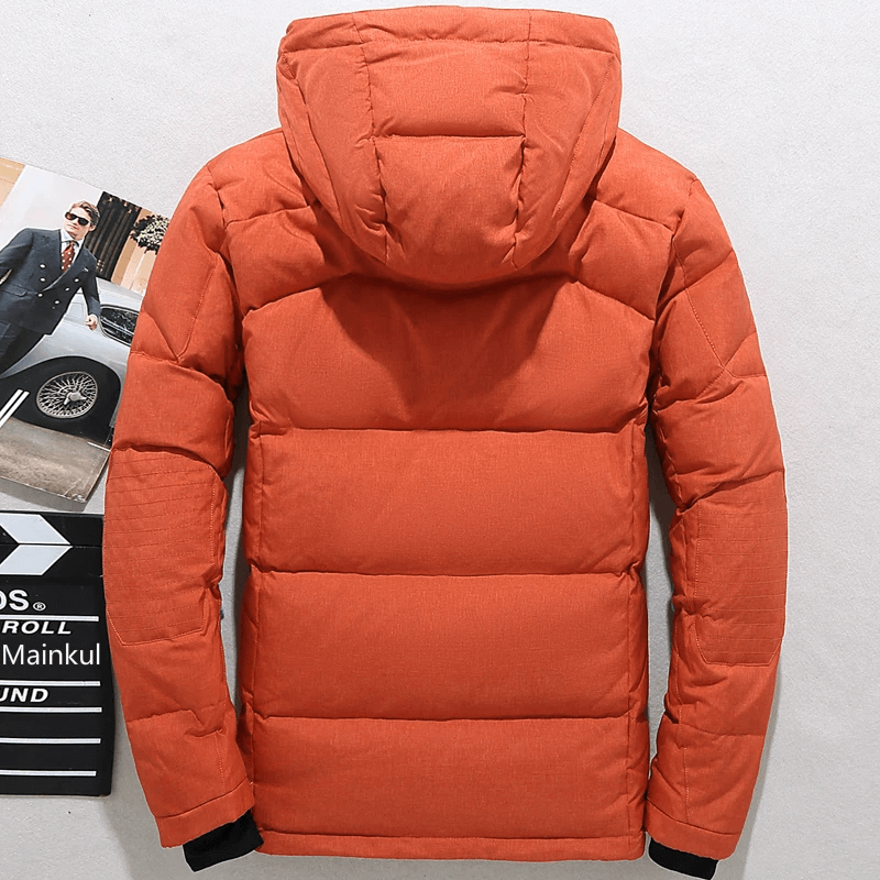 Warm orange ski jacket with hood, perfect for windproof performance on the slopes. Ideal for men's winter sports fashion.