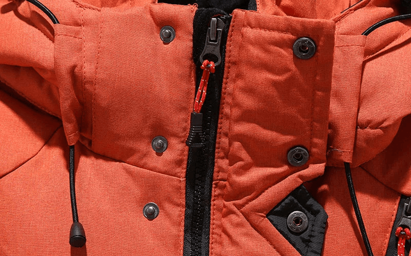 Close-up of orange hooded ski jacket with buttons and zipper, part of the Men's Windproof Ski Suit SF2045, showcasing durable polyester material.
