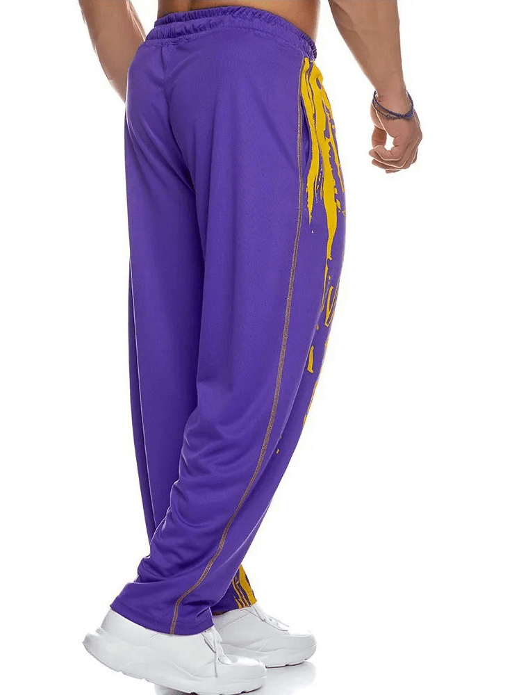 Men's purple drip print athletic sweatpants, fitted for gym or running. Stylish joggers with snug fit and drawstring closure.