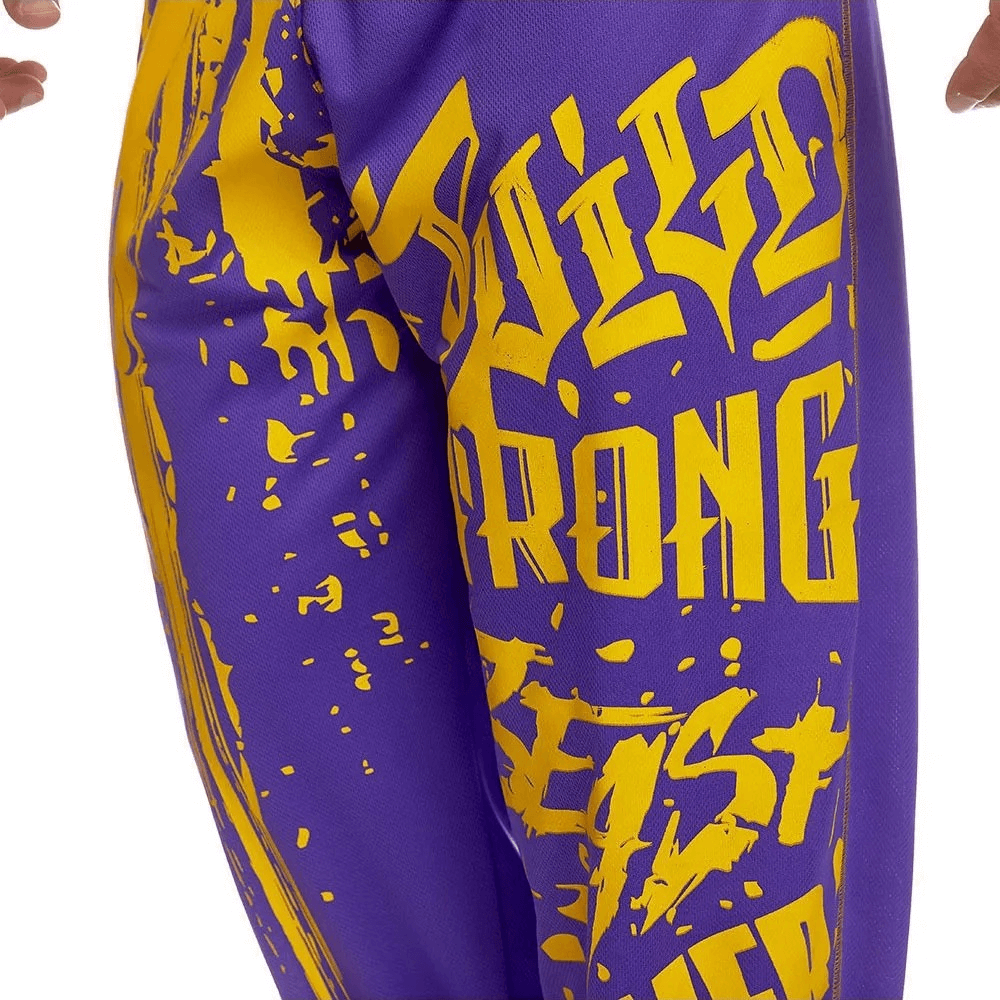 Men's purple drip print sweatpants with bold yellow typography, designed for athletic comfort and style, perfect for gym workouts.