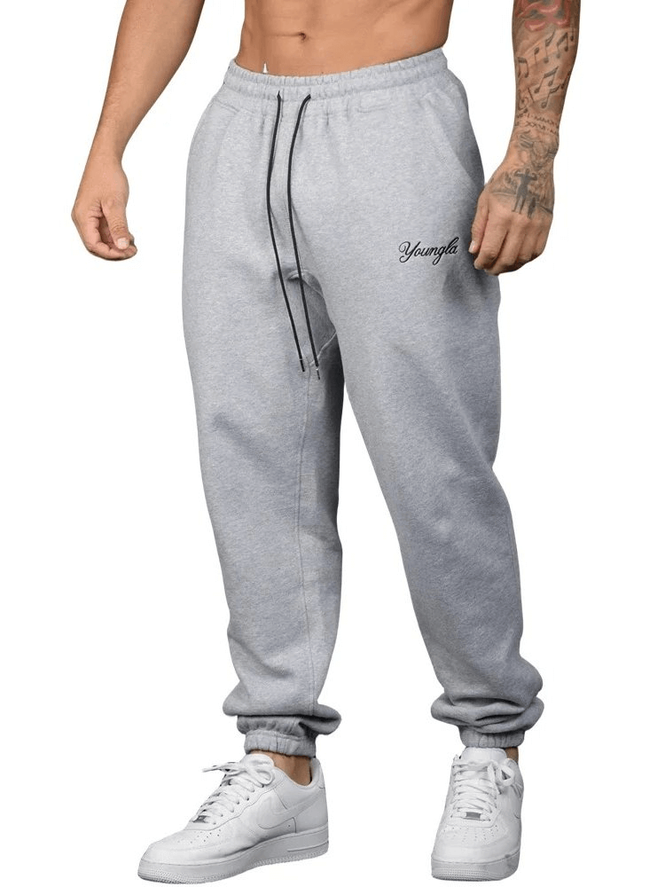 Men's athletic joggers SF1951 in gray, mid-waist design with drawstring for comfort and durability, featuring bold lettering.
