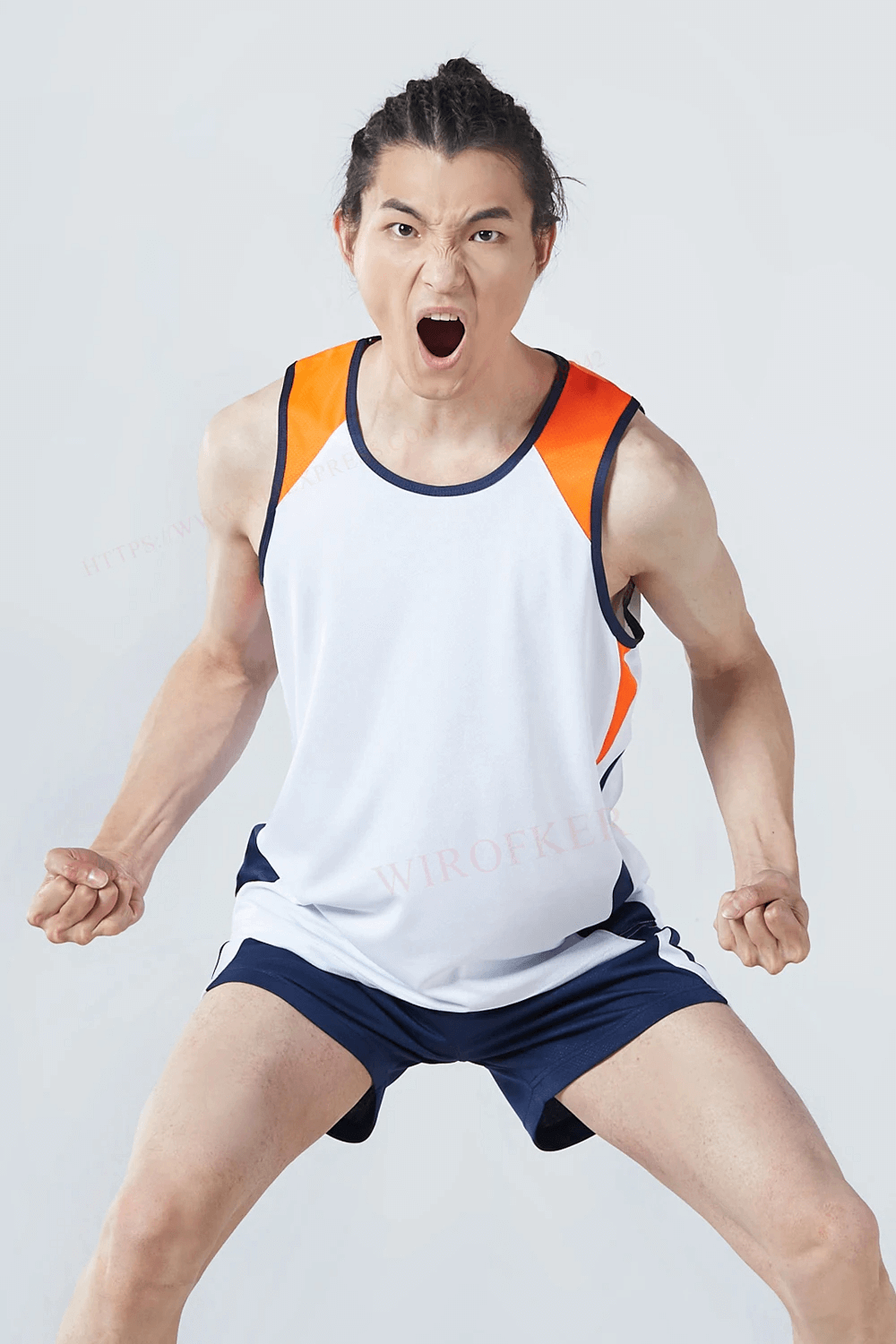 Man wearing Men's Athletic Mesh Tank Top and Shorts Set SF2042 in white, orange, and blue, expressing energy and readiness for sports.
