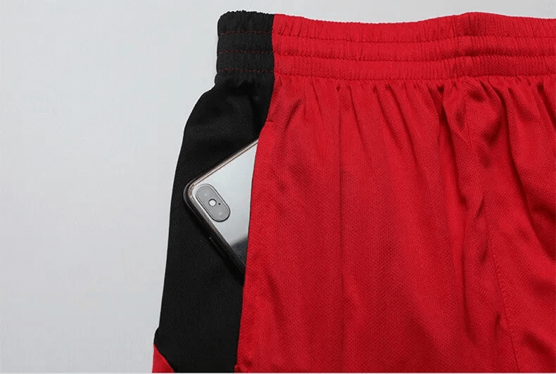 Red athletic shorts with a handy phone pocket, highlighting sporty style and functionality.