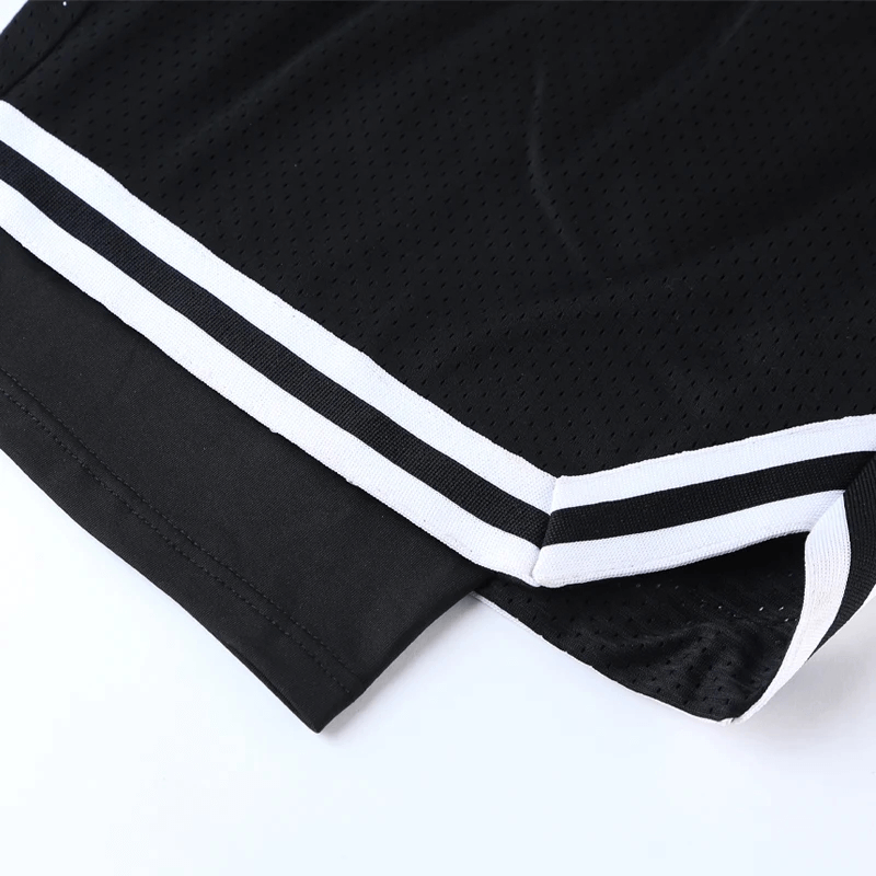 Black men's basketball shorts with stylish white stripes and breathable mesh layer for enhanced performance on and off the court.