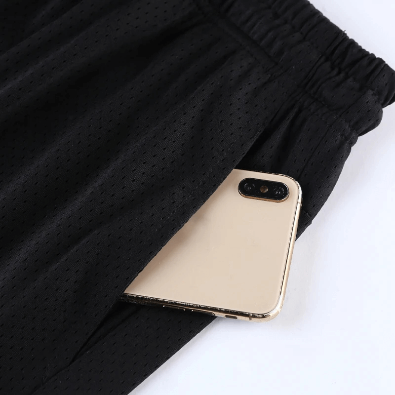 Close-up of black mesh basketball shorts with a convenient phone pocket, perfect for training and style.