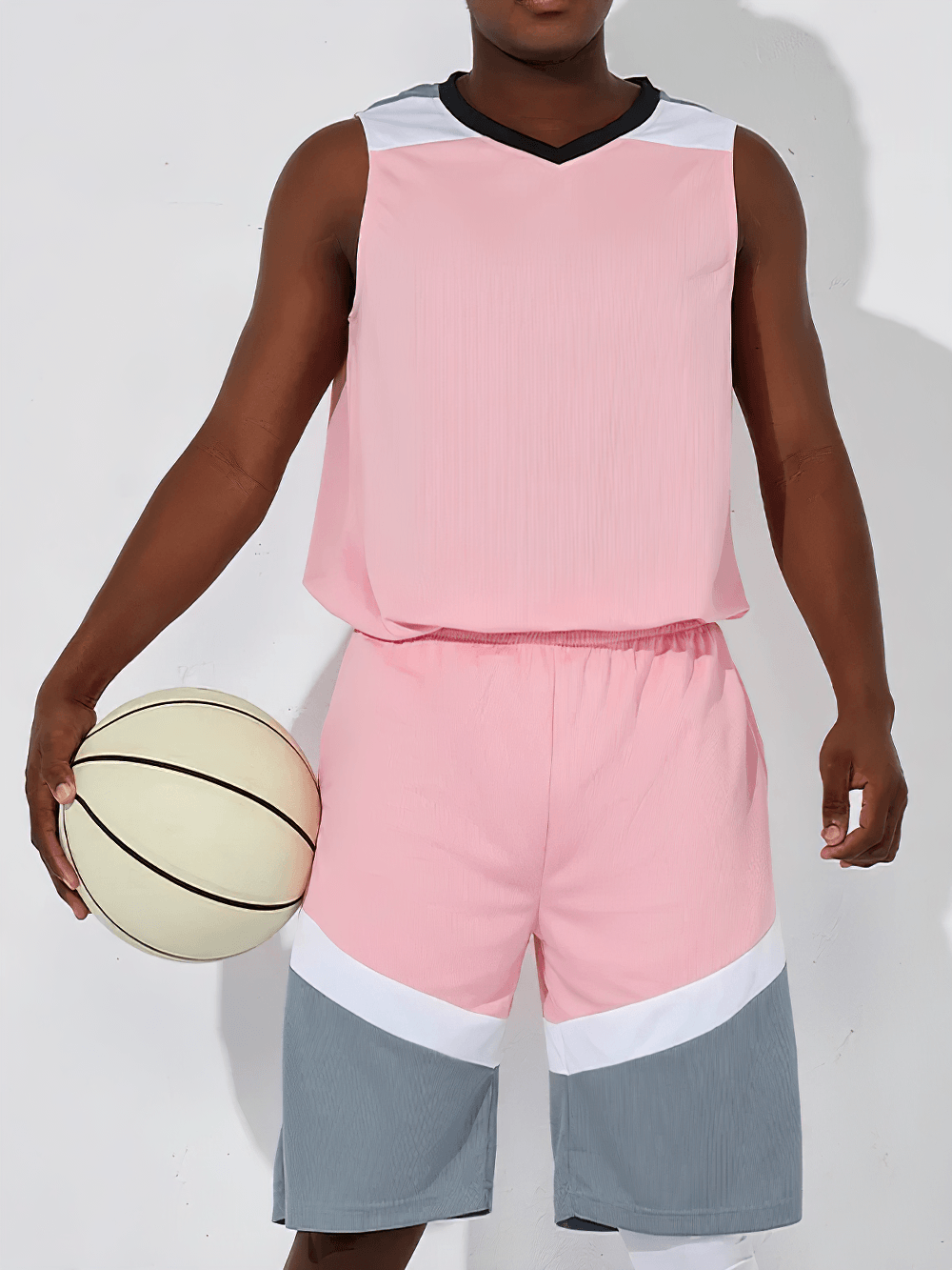 Men's Basketball Jersey and Shorts Training Set - SF4557 in pink and gray worn by a player holding a basketball.